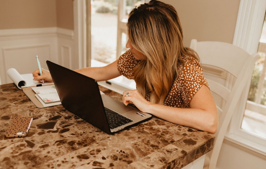 RAB Marketing strategist planning a client website at her laptop